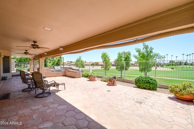 view of patio with ceiling fan and area for grilling