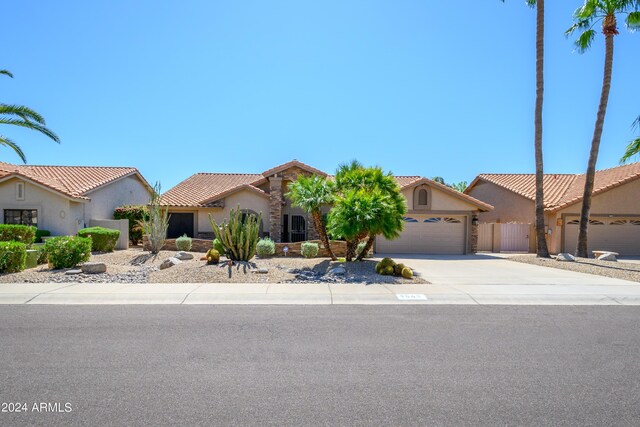 mediterranean / spanish home featuring a garage