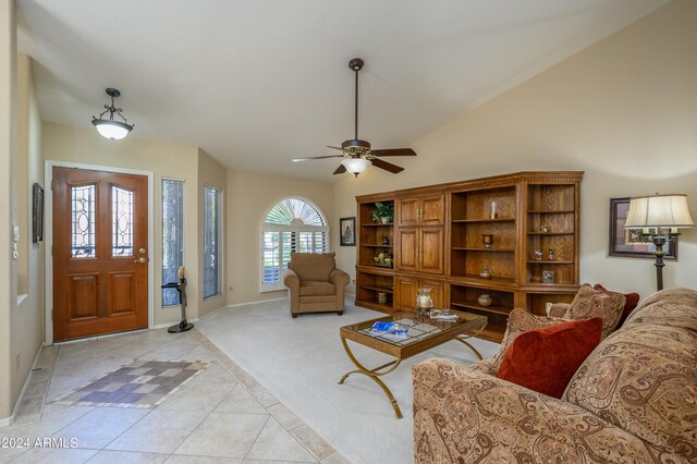 tiled living room featuring lofted ceiling and ceiling fan