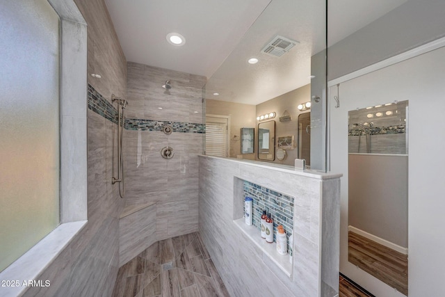 bathroom with a tile shower