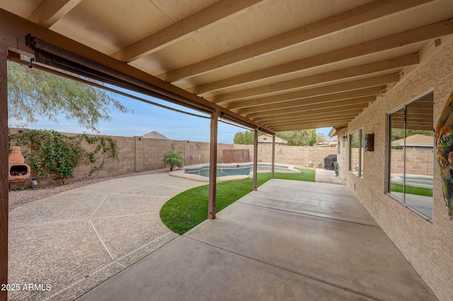 view of patio / terrace featuring a fenced in pool and exterior fireplace