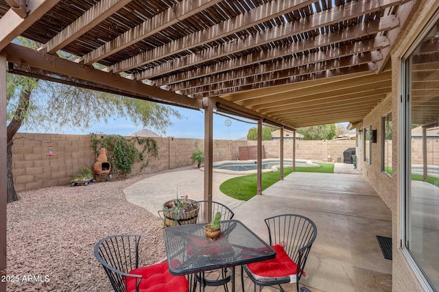 view of patio / terrace with a fenced in pool and a fireplace