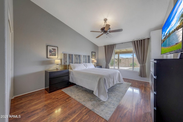 bedroom featuring ceiling fan, dark hardwood / wood-style floors, and vaulted ceiling