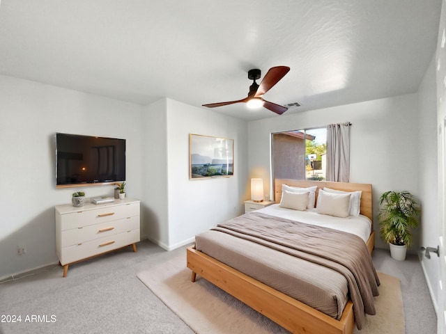 bedroom with light colored carpet and ceiling fan