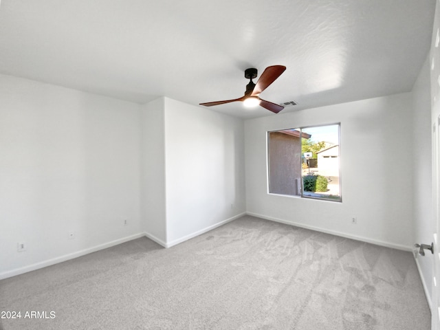 unfurnished room featuring light colored carpet and ceiling fan