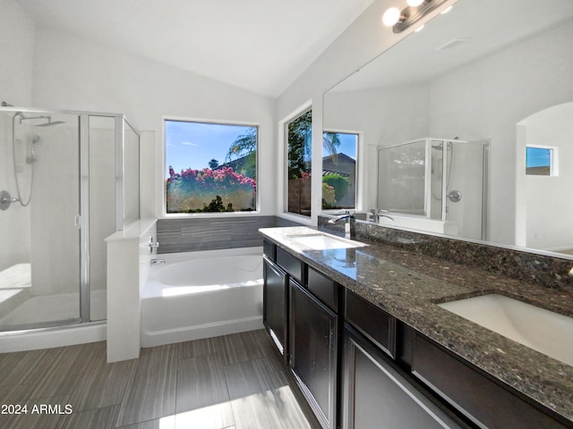 bathroom with vanity, lofted ceiling, and plus walk in shower