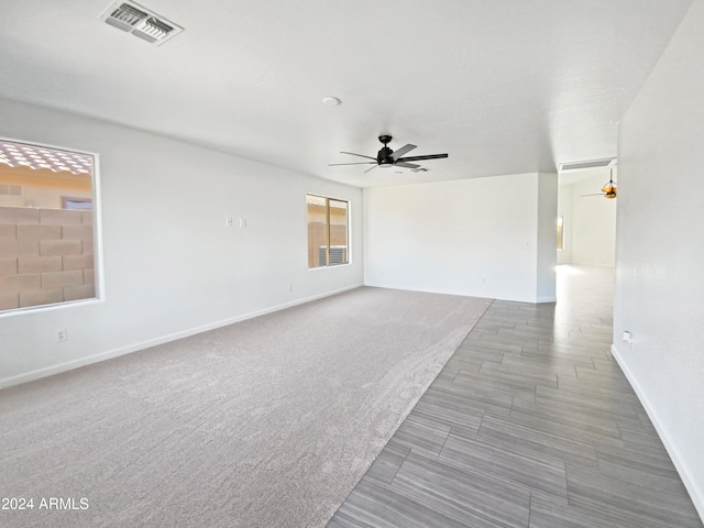 carpeted empty room featuring ceiling fan