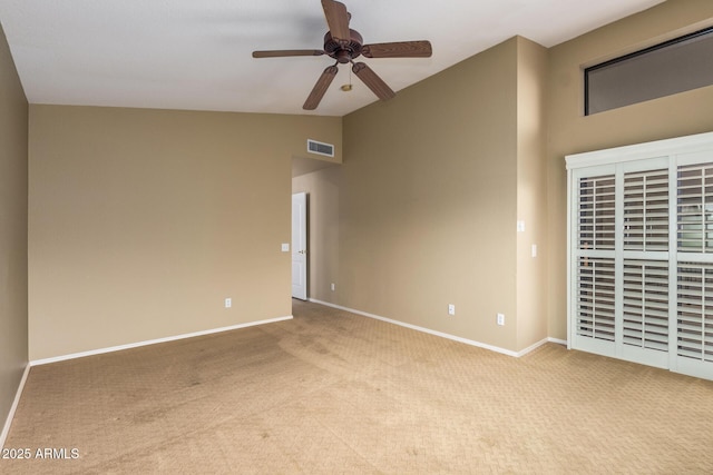 unfurnished room with ceiling fan, carpet flooring, visible vents, baseboards, and vaulted ceiling