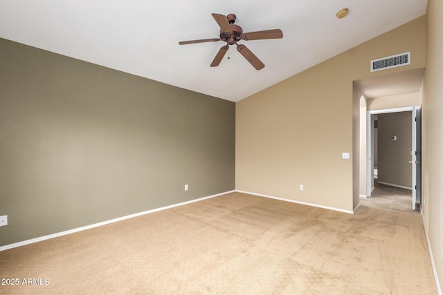 unfurnished room featuring lofted ceiling, baseboards, visible vents, and light colored carpet