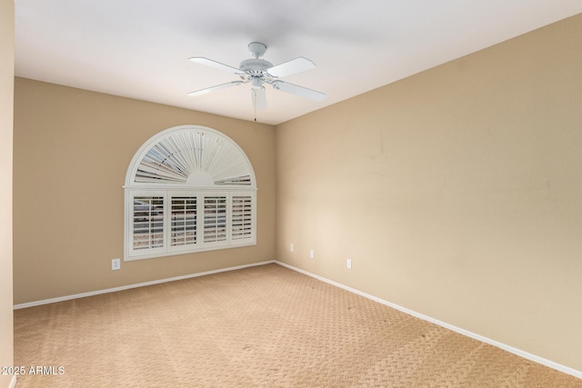 empty room featuring ceiling fan, carpet floors, and baseboards