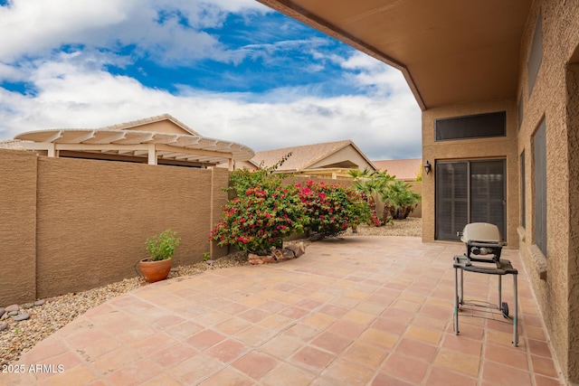 view of patio featuring fence