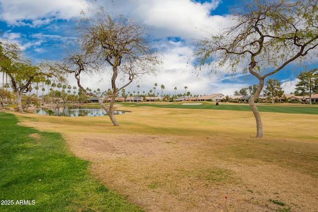 surrounding community featuring a water view and a yard