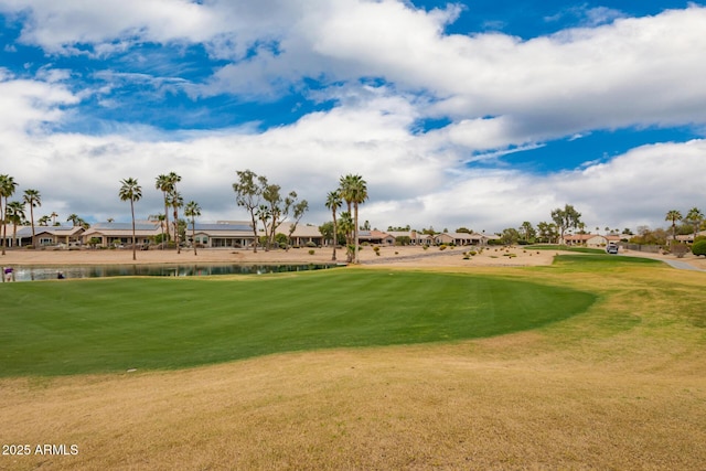 surrounding community with view of golf course, a water view, and a lawn