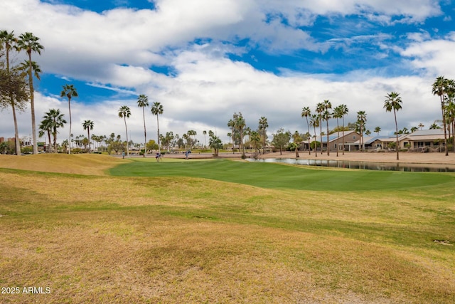 view of community with a water view, a yard, and golf course view