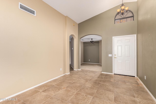 foyer entrance featuring arched walkways, visible vents, high vaulted ceiling, baseboards, and ceiling fan with notable chandelier