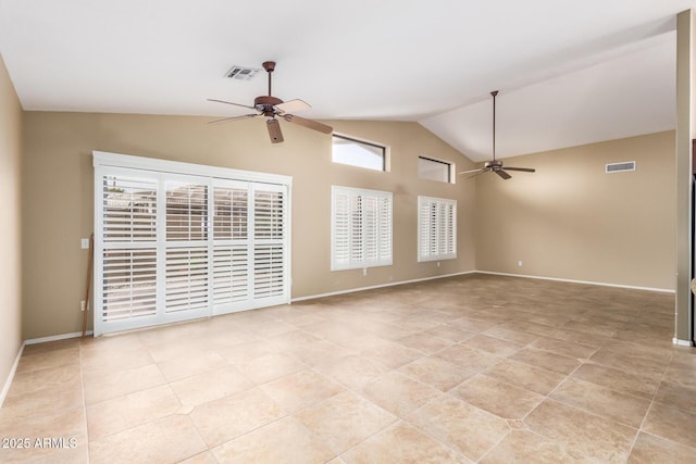 spare room with light tile patterned floors, visible vents, a ceiling fan, vaulted ceiling, and baseboards