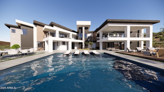 rear view of property with a balcony, a patio area, and an outdoor pool