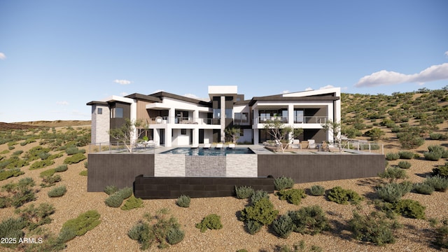 rear view of property with an outdoor pool, stucco siding, a balcony, and a patio area