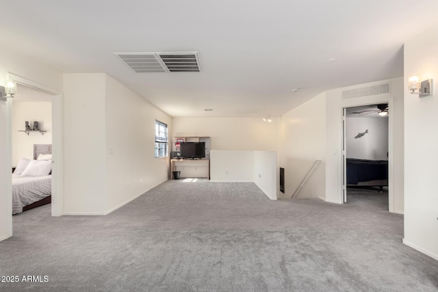 carpeted spare room with baseboards and visible vents