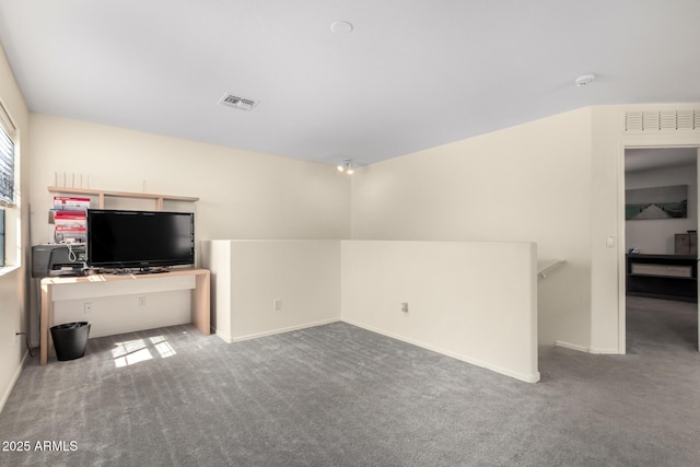 unfurnished living room featuring carpet, visible vents, and baseboards