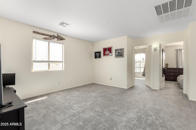 unfurnished bedroom featuring carpet floors, baseboards, and visible vents