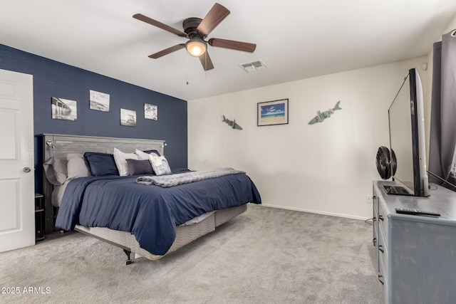 carpeted bedroom with a ceiling fan, visible vents, and baseboards