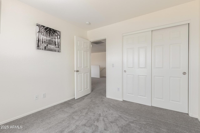 unfurnished bedroom featuring a closet, carpet, visible vents, and baseboards