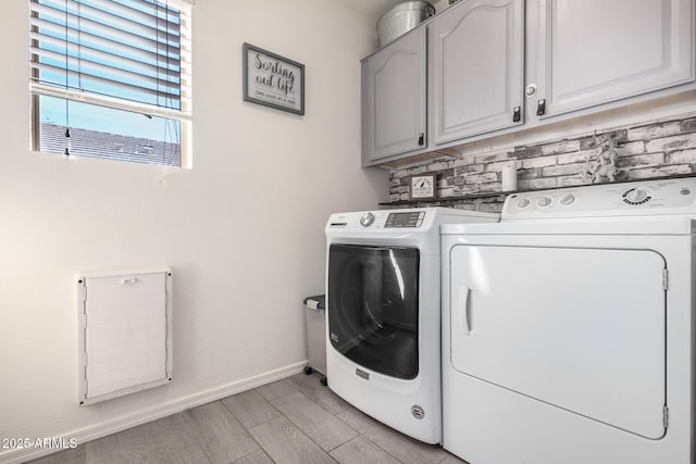 washroom with washer and clothes dryer, light wood-type flooring, cabinet space, and baseboards