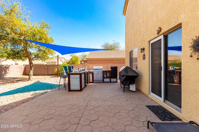 view of patio / terrace featuring a grill, a fenced backyard, and outdoor dining space