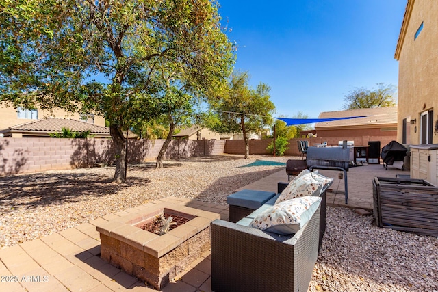 view of patio / terrace with a fenced backyard and an outdoor living space with a fire pit