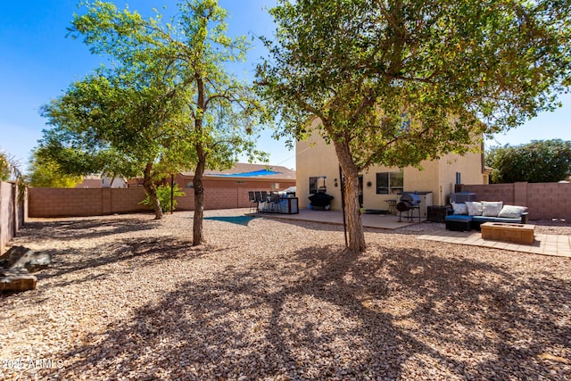 back of property with a patio area, a fenced backyard, and an outdoor hangout area