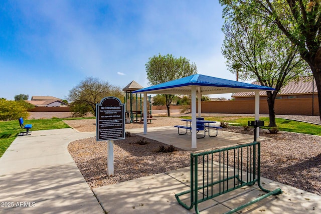 view of home's community with playground community and fence