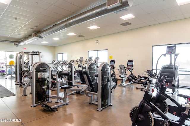 gym featuring visible vents and a paneled ceiling