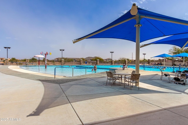 pool featuring a patio area and fence