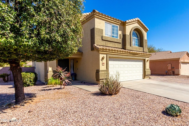 mediterranean / spanish-style house featuring concrete driveway, a tile roof, an attached garage, and stucco siding