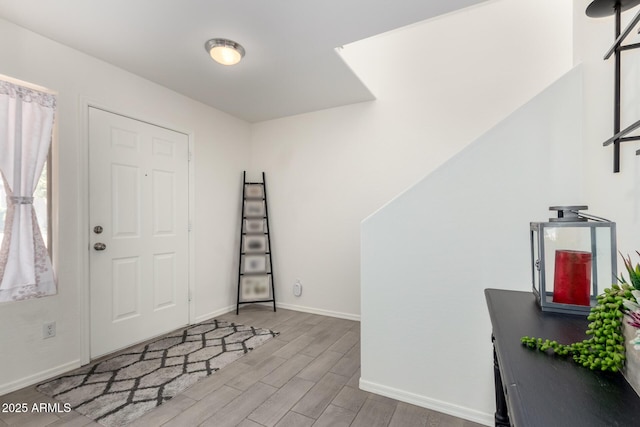 entrance foyer with baseboards and light wood finished floors