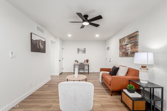 living room with ceiling fan and light wood-type flooring