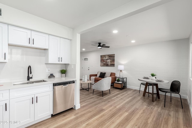 kitchen with white cabinetry, dishwasher, sink, ceiling fan, and light hardwood / wood-style floors