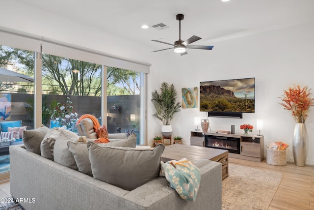 living room featuring light wood-type flooring and ceiling fan