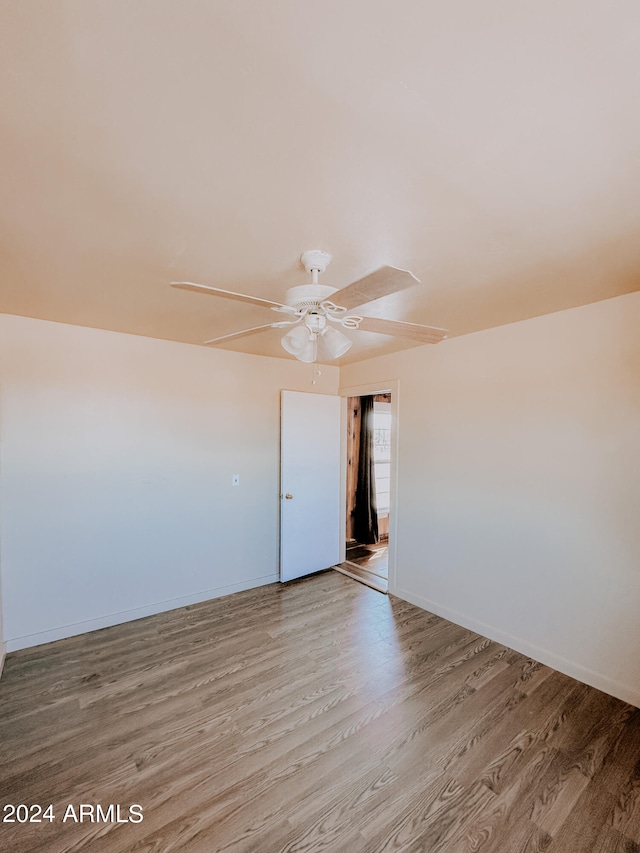 empty room featuring ceiling fan and hardwood / wood-style flooring