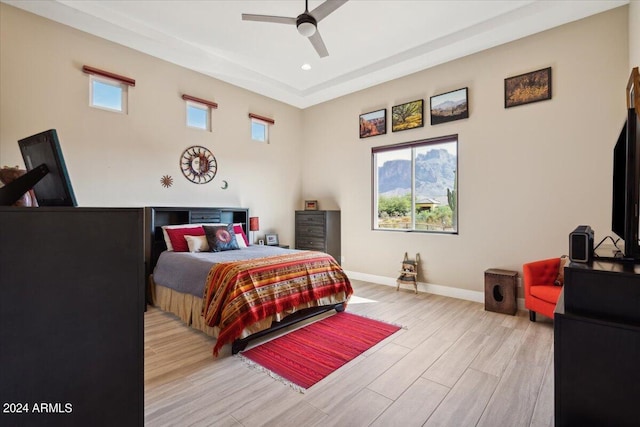 bedroom with light hardwood / wood-style floors and ceiling fan