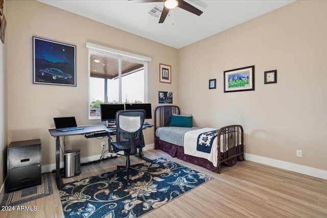 bedroom with ceiling fan and hardwood / wood-style flooring