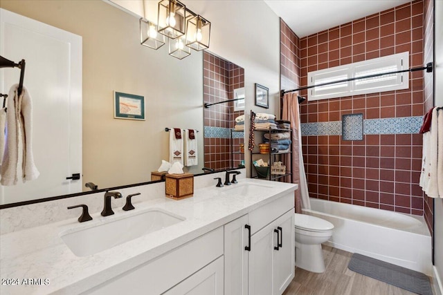 full bathroom featuring vanity, toilet, hardwood / wood-style flooring, and shower / tub combo with curtain