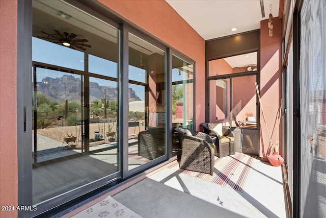 entryway with ceiling fan and a mountain view