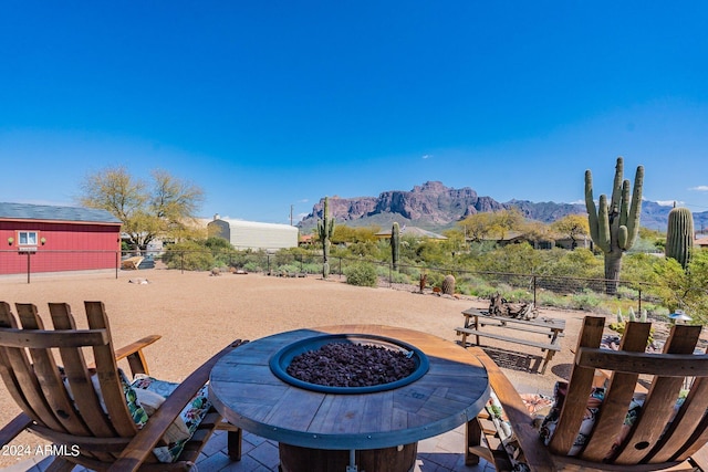 view of patio / terrace featuring a mountain view and a fire pit