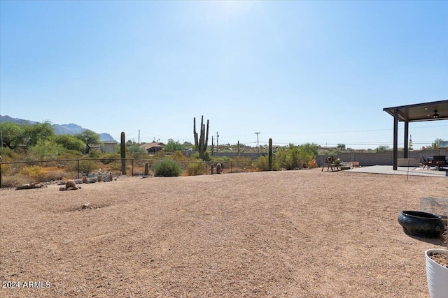 view of yard with a patio and a mountain view