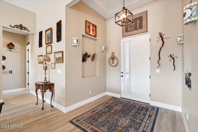 entryway with a notable chandelier and hardwood / wood-style floors