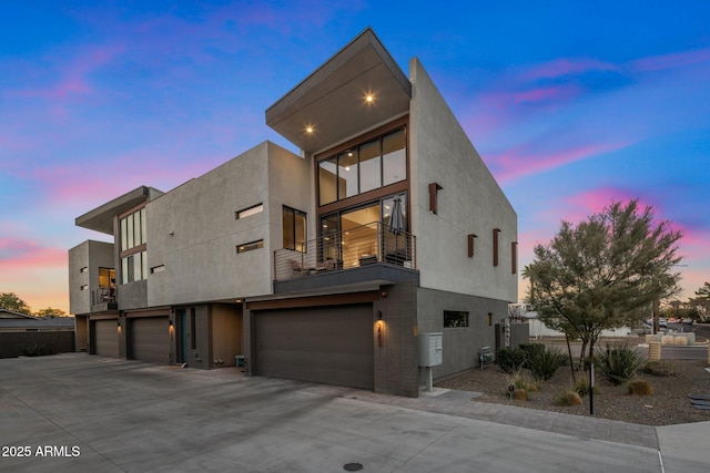 view of front of home featuring a garage and a balcony