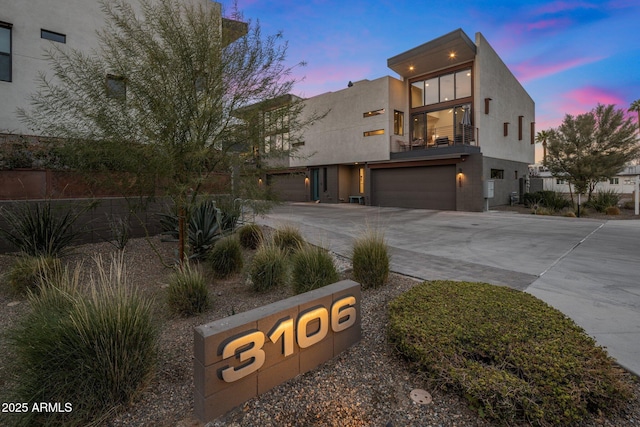 view of front of home featuring a garage and a balcony