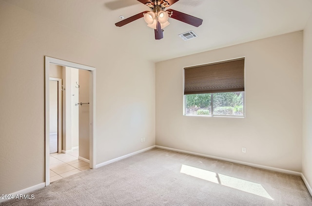 spare room with light carpet and ceiling fan